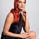 Model in black dress with red hair 