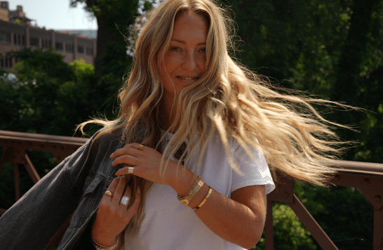 Lifestyle Model twirling and showcasing her styled hair.
